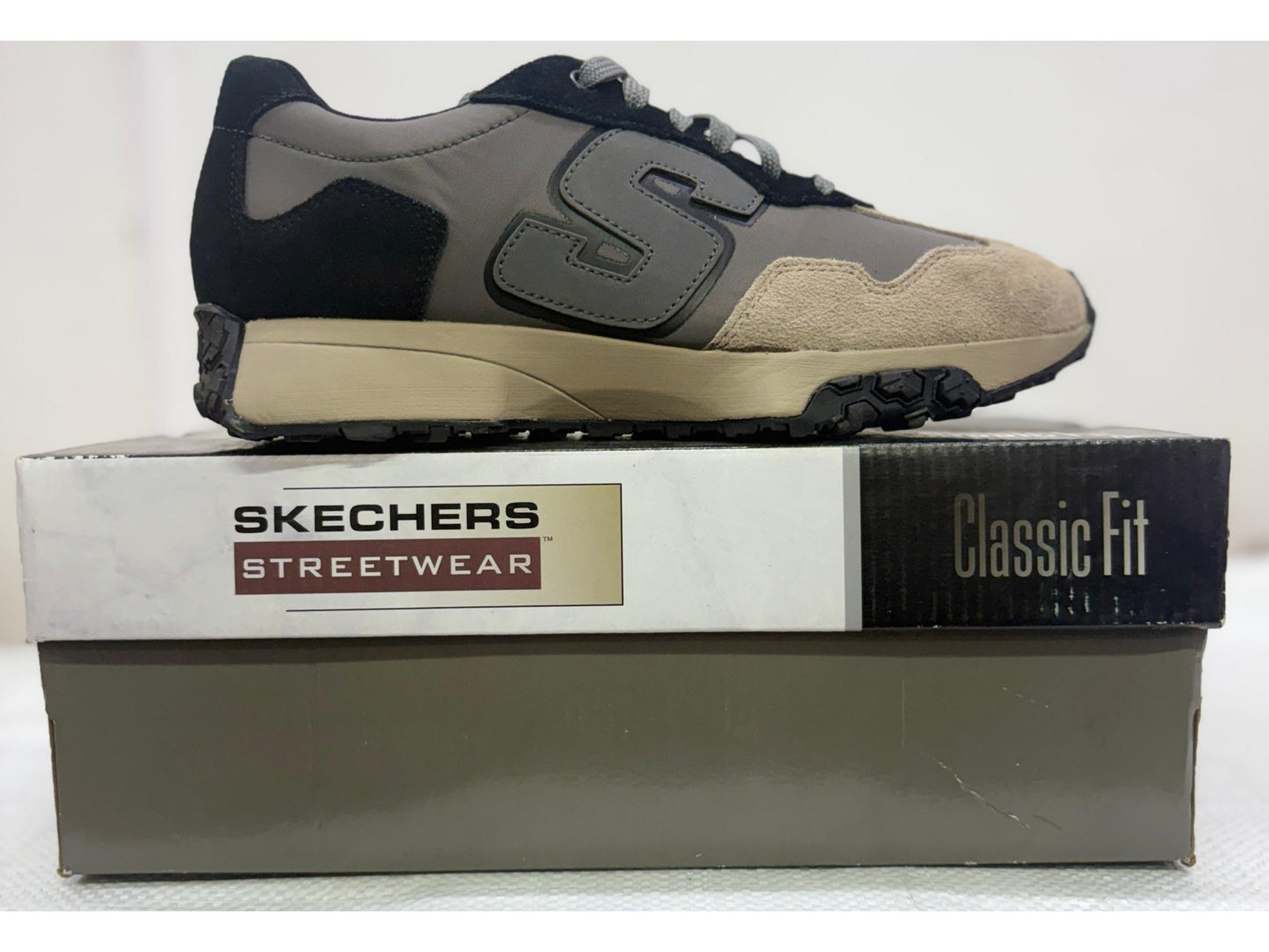 Side profile of a charcoal and tan Skechers Streetwear Classic Fit sneaker with black lugged outsole
