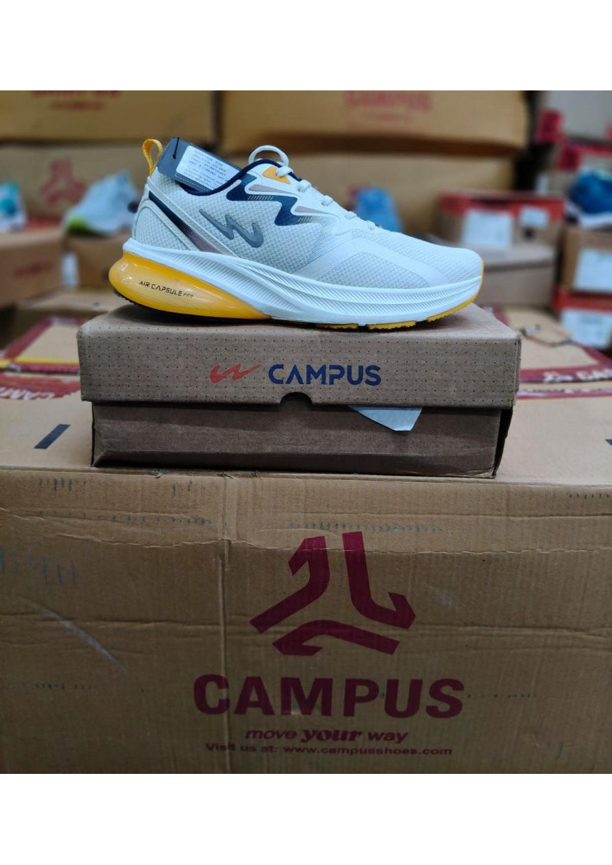 White Campus Air Capsule Pro running shoe with navy collar, yellow heel pull tab, and translucent yellow air unit in heel.