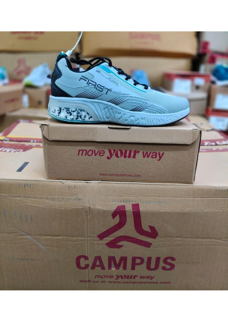 Light blue Campus First running shoe with bold FIRST side branding and clear bead-filled heel cushioning unit.