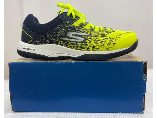 Navy and neon yellow Skechers Arch Fit athletic shoe with white midsole on blue shoebox.