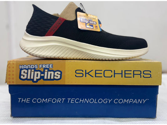 Side view of a black Skechers Hands Free Slip-ins walking shoe with red heel accent and cream midsole on branded yellow and blue box.