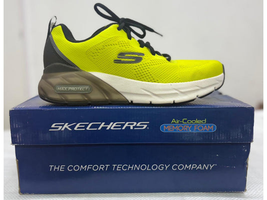 Side view of a neon yellow Skechers Max Protect shoe with translucent grey heel unit and white forefoot midsole