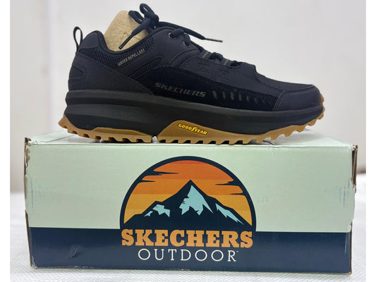 Side view of a black Skechers Outdoor walking shoe with gum Goodyear outsole and water-repellent upper, resting on Skechers Outdoor box