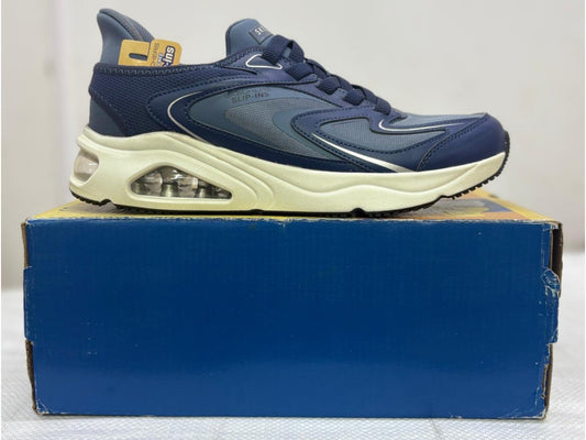 Navy Skechers Hands Free Slip-ins sneaker with visible air-cushioned heel and cream midsole on blue box.
