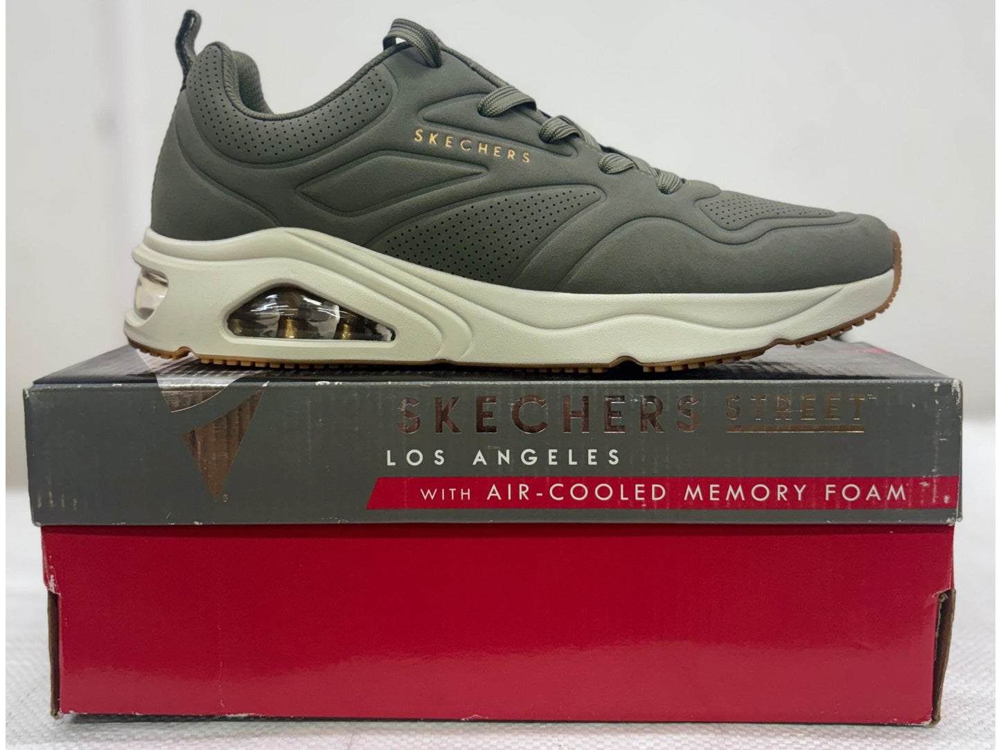 Side view of an olive green Skechers Street Uno with cream midsole, Skech-Air heel, and gum outsole