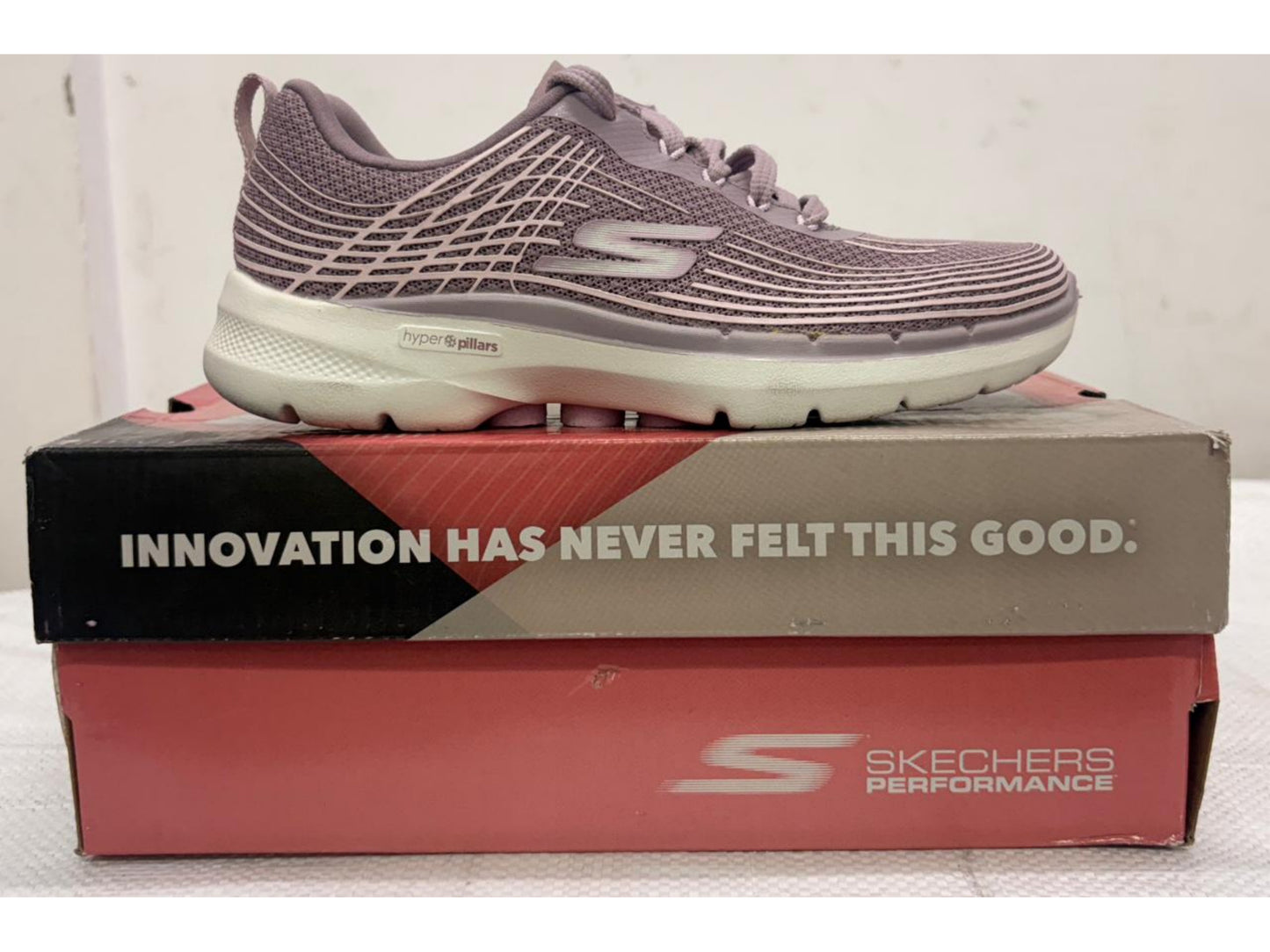 Mauve Skechers GO WALK 6 women's walking shoe with white Hyper Pillars midsole on Skechers Performance box.