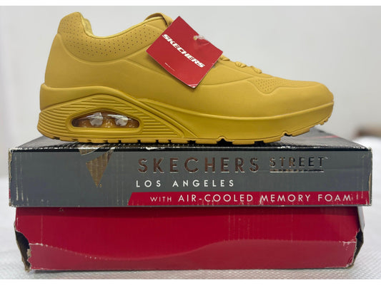 Side view of a monochromatic mustard yellow Skechers Street Uno with visible air-cushioned heel